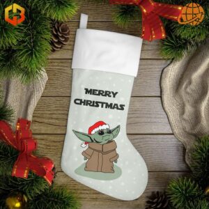 Baby Yoda Merry Christmas Stocking displayed on wooden surface surrounded by pine branches, pinecones, and red ribbons, showcasing Baby Yoda in Santa hat with "MERRY CHRISTMAS" text.