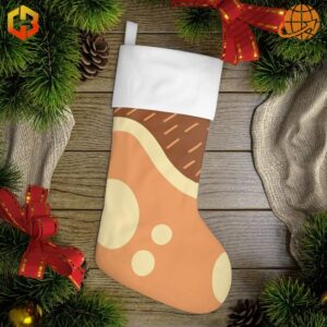 Bluey Chilli Heeler Christmas Stocking featuring orange body with cream spots, brown top, and white cuff, displayed on wooden background with pine branches and holiday decorations.