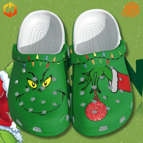 Christmas Light Grinch Crocs Shoes displayed on snowy green background, showcasing festive Grinch-themed design.