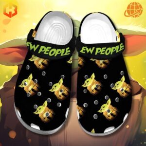 Ew People Baby Yoda Crocs Shoes displayed against a bright yellow background, showcasing the black color, Baby Yoda illustrations, and green 