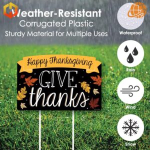 A yard sign featuring black color and the text 'Give Thanks Happy Thanksgiving'.