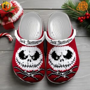 Jack Skellington Crocs Shoes in red with white knitted skull design, displayed with Christmas decorations on a wooden surface.