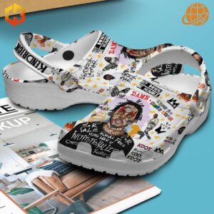 Side view of Kendrick Lamar Humble Crocs Shoes displaying detailed artwork and "KENDRICK" on the heel strap.