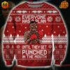 Mike Tyson Christmas Sweater with pixelated boxer image and quote "Everyone has a plan until they get punched in the mouth" on red background with festive patterns.