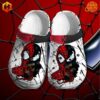 Spiderman mix Venom Crocs Shoes featuring split-face design on white clogs with red and black heel strap, set against Spider-Man web background.