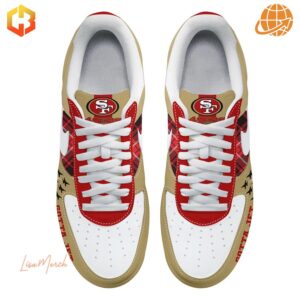 Overhead view of San Francisco 49ers themed Nike Air Force 1 sneakers, showing red, gold, and white color scheme with team logos.